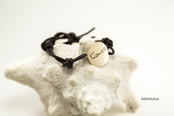 Large round (20mm) bracelet shown in brass with polished finish, brown leather cord (2mm) and Bermuda border charm. A button closure is available for a small upcharge.