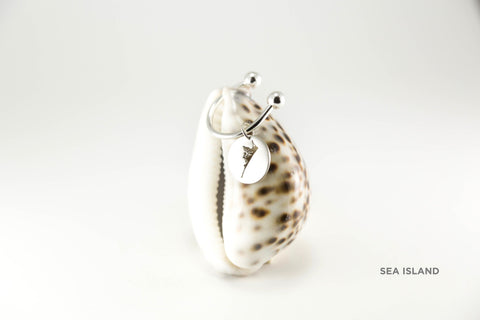 Horseshoe key ring shown in sterling silver, including small medallion with matte finish and Sea Island border.