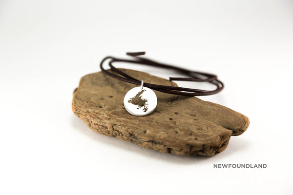 Large medallion (app. 20mm) necklace shown in sterling silver with matte finish, leather cord and Newfoundland border.